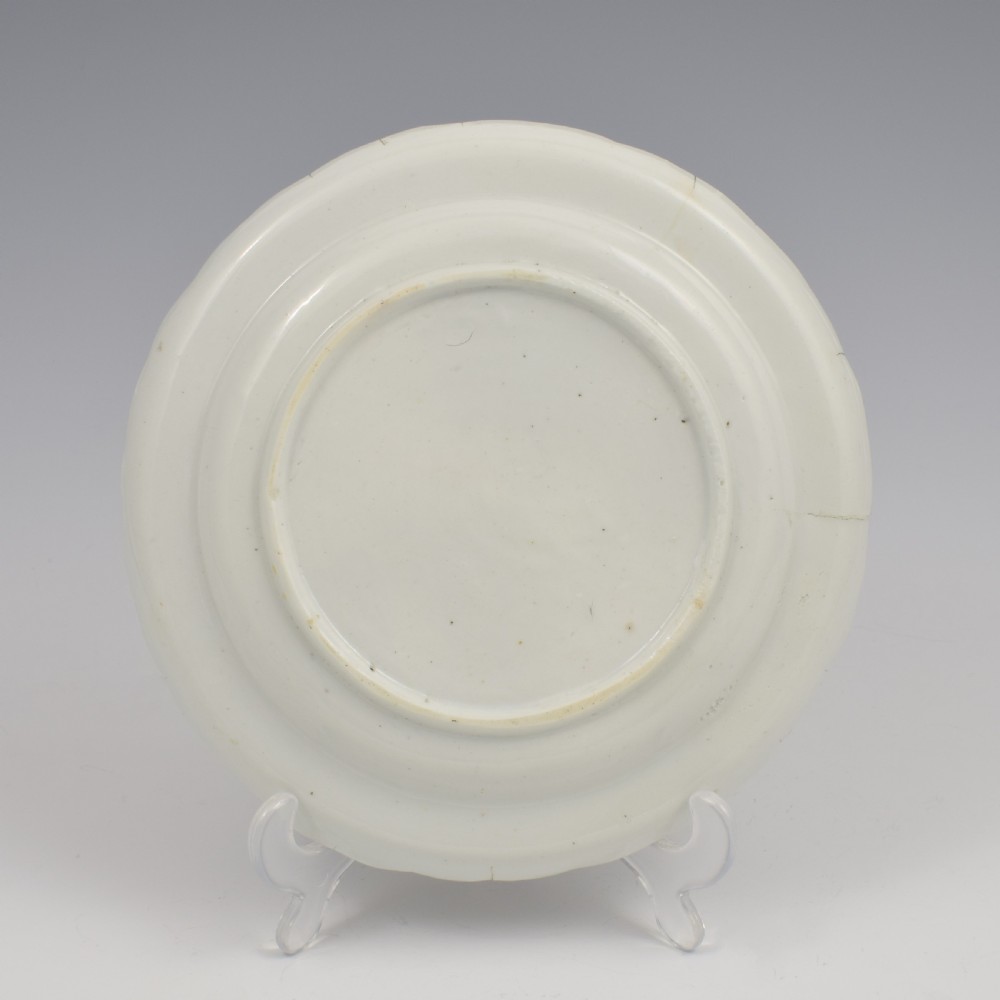 An 18th-century English soft-paste porcelain lobed plate decorated with hand-painted polychrome floral sprays and a brown line rim. View VI