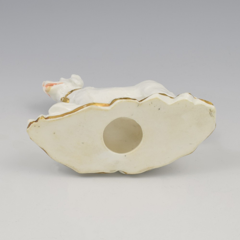 A white glazed porcelain figure of a standing gundog on a molded base with gold gilded accents along the collar and base rim. View XI