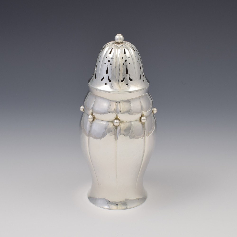 An Art Nouveau Danish sterling silver sugar caster featuring a lobed body with applied bead details and a hand-pierced domed cover. View III