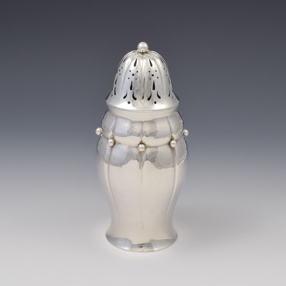 An Art Nouveau Danish sterling silver sugar caster featuring a lobed body with applied bead details and a hand-pierced domed cover. View VI