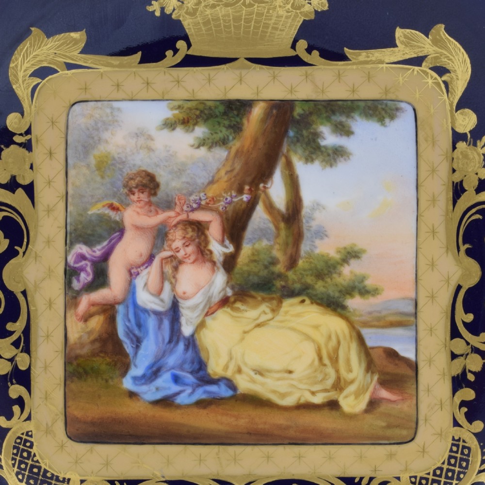 A cobalt blue and gilt porcelain cabinet plate featuring a pierced reticulated border and a central hand-painted square scene of Cupid and Psyche. View III