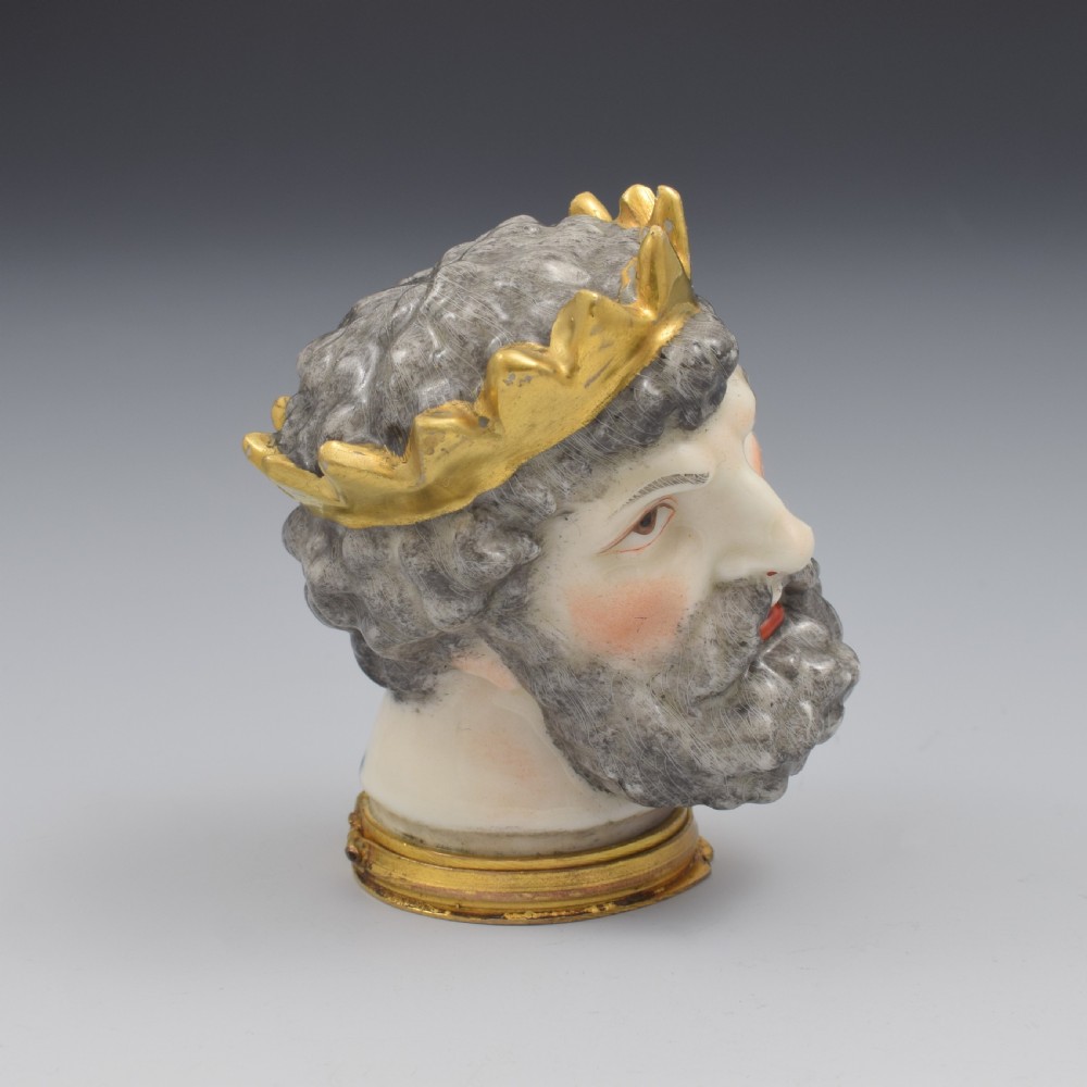 A French porcelain bonbonniere crafted in the shape of the bearded god Neptune with a gilt crown and mounted on a brass rim base. View III