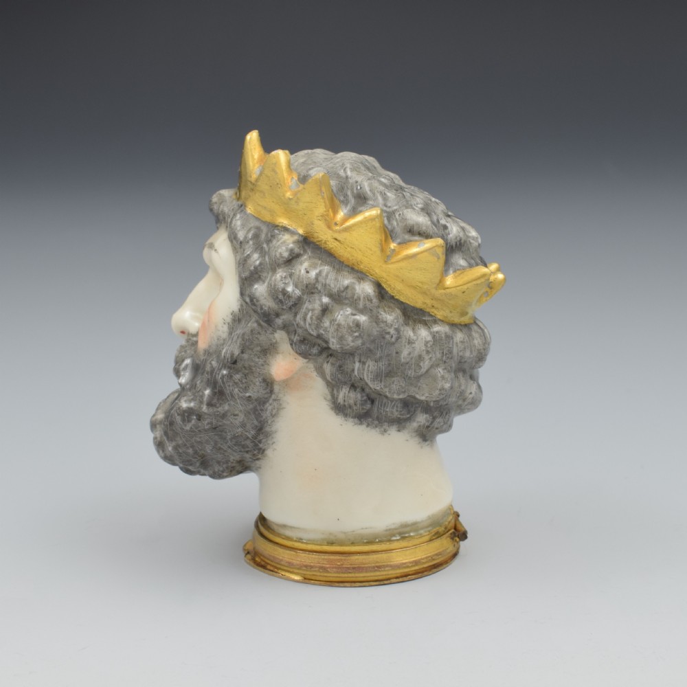 A French porcelain bonbonniere crafted in the shape of the bearded god Neptune with a gilt crown and mounted on a brass rim base. View VII
