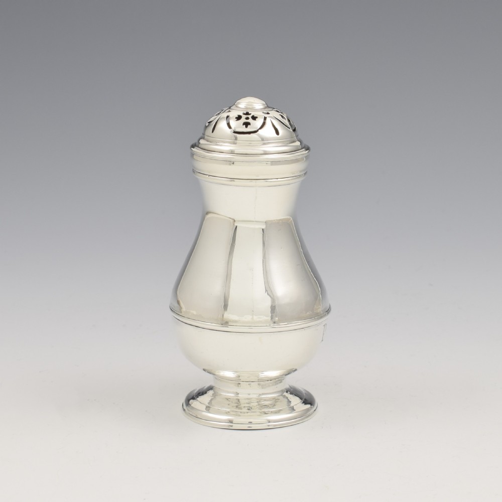A George I sterling silver pounce pot with a faceted baluster body, stepped pedestal base, pierced dome cover, and engraved initials. View II