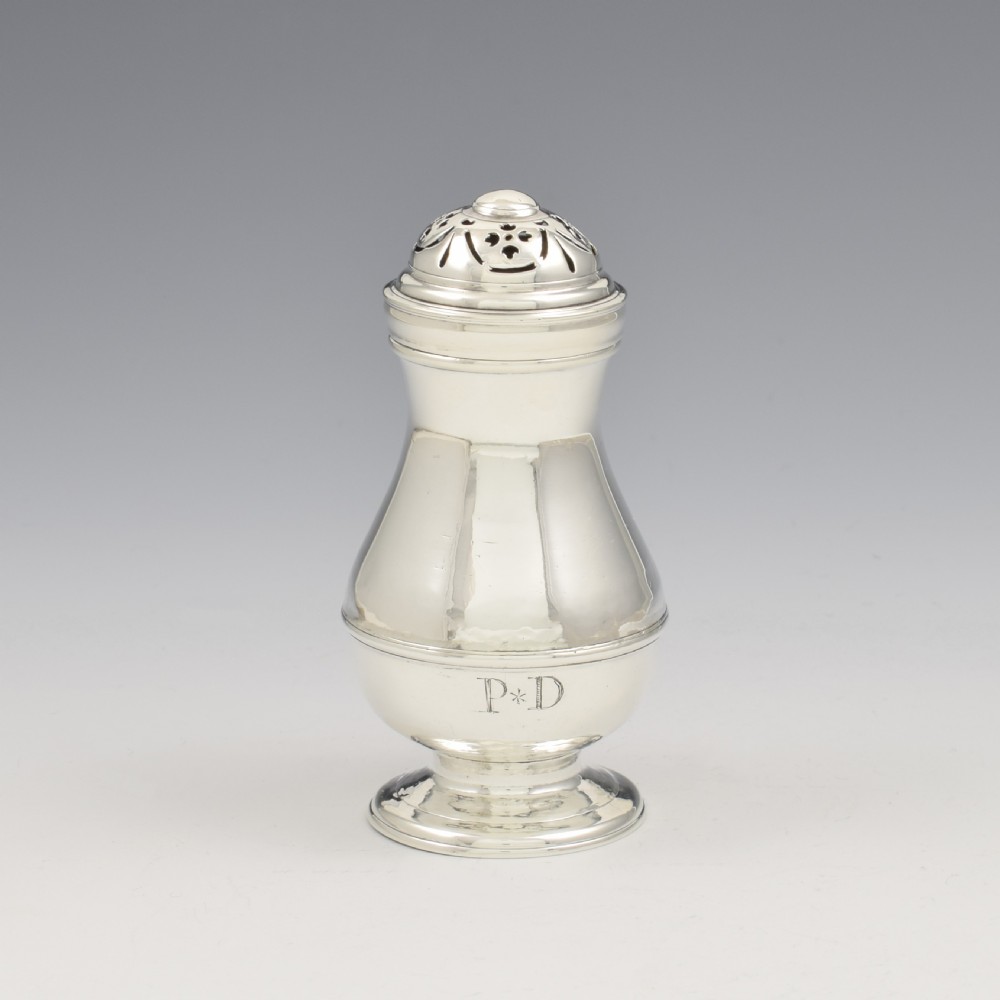 A George I sterling silver pounce pot with a faceted baluster body, stepped pedestal base, pierced dome cover, and engraved initials. View III