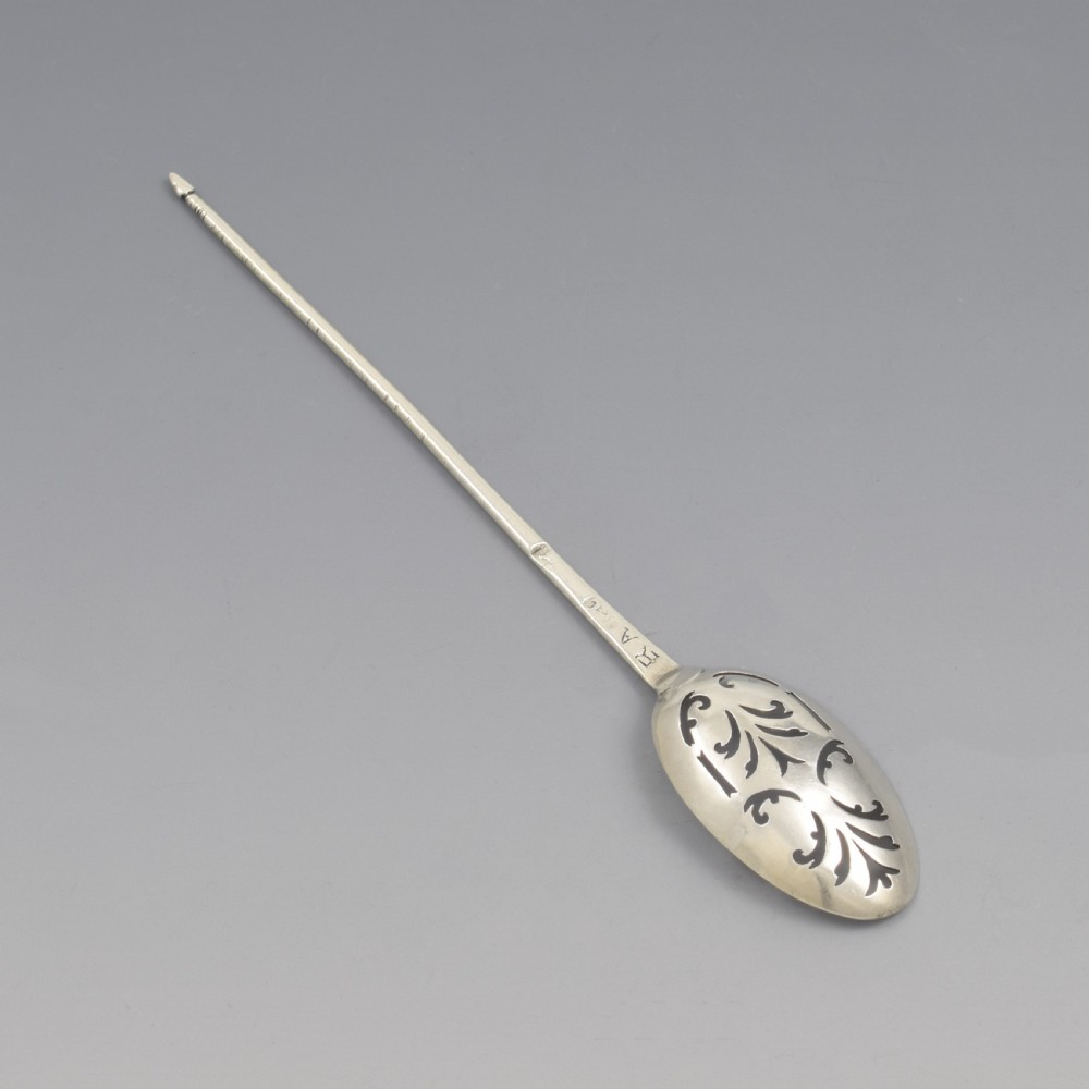 A George II sterling silver mote spoon featuring a pierced oval bowl with scrollwork fretwork and a long tapered spike stem. View V
