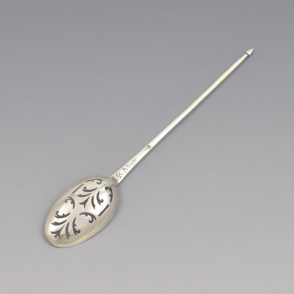 A George II sterling silver mote spoon featuring a pierced oval bowl with scrollwork fretwork and a long tapered spike stem. View VI