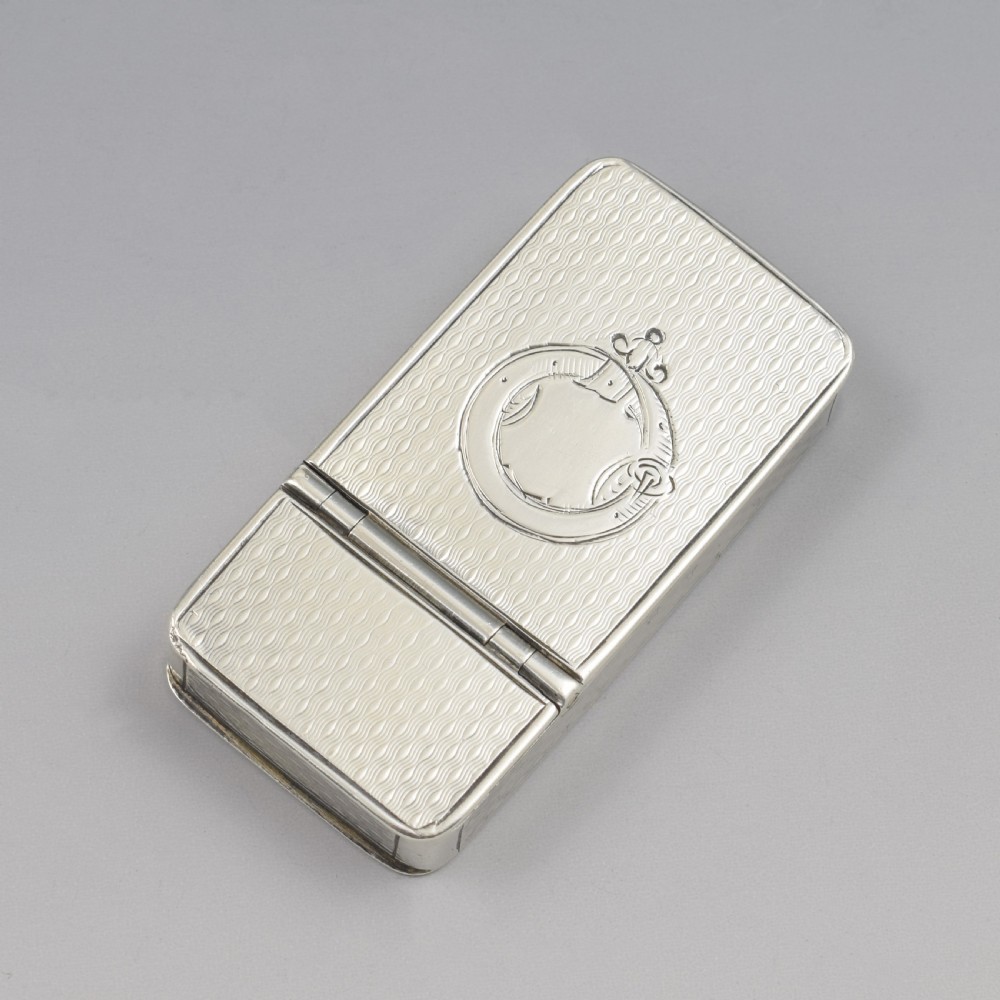 A rectangular Victorian sterling silver pocket box featuring two hinged lids, engine-turned wave engraving, and a central circular cartouche.