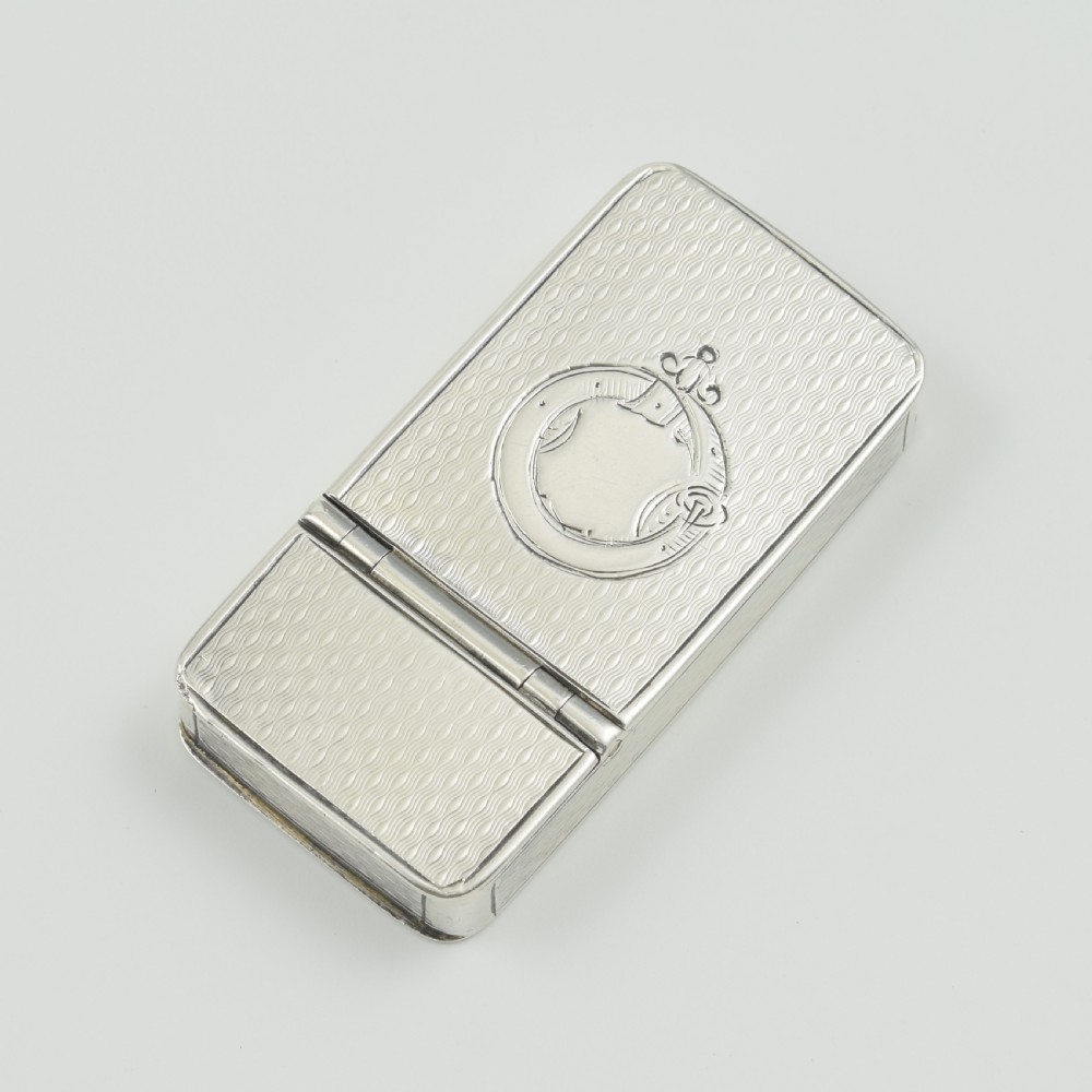 A rectangular Victorian sterling silver pocket box featuring two hinged lids, engine-turned wave engraving, and a central circular cartouche. View II