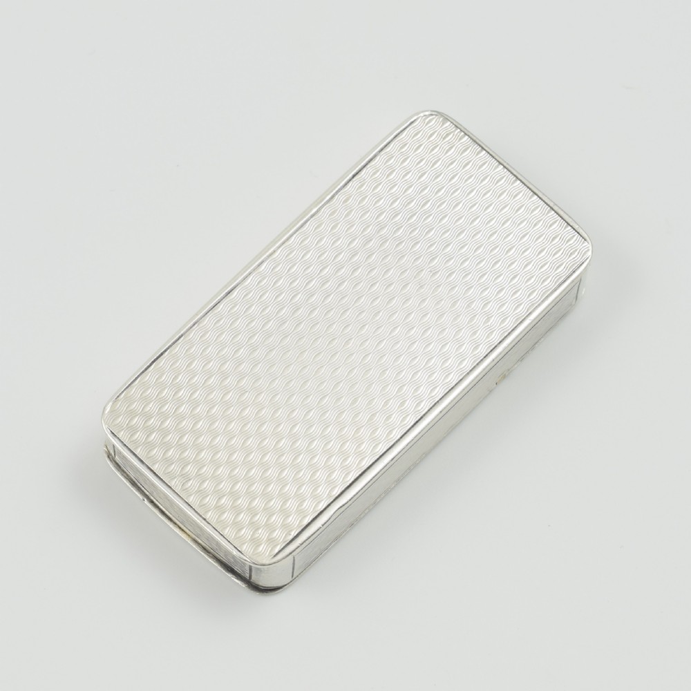 A rectangular Victorian sterling silver pocket box featuring two hinged lids, engine-turned wave engraving, and a central circular cartouche. View X