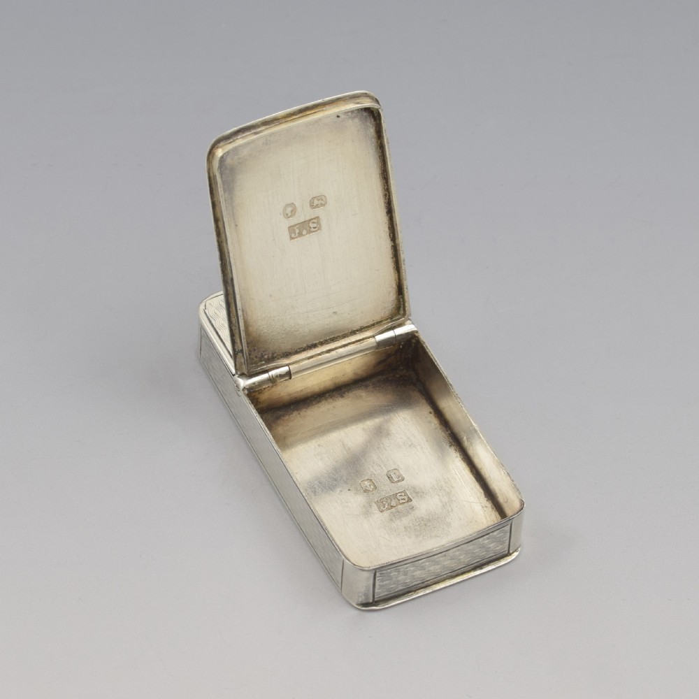 A rectangular Victorian sterling silver pocket box featuring two hinged lids, engine-turned wave engraving, and a central circular cartouche. View XVI