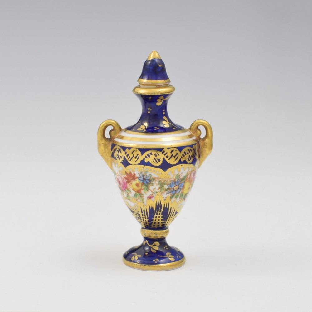 An Edwardian miniature cobalt blue porcelain scent bottle in urn form with twin gilt handles and hand-painted floral panels. View III