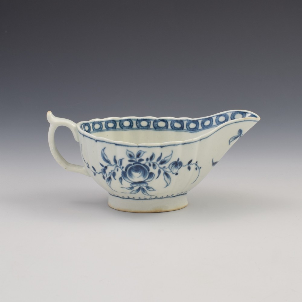 An eighteenth-century First Period Worcester blue and white soft-paste porcelain sauce boat featuring hand-painted rose motifs and a moulded body. View VI