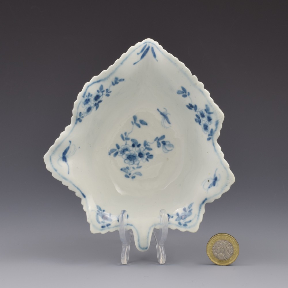 An 18th-century leaf-moulded soft-paste porcelain pickle dish with underglaze cobalt blue floral and leaf decoration.