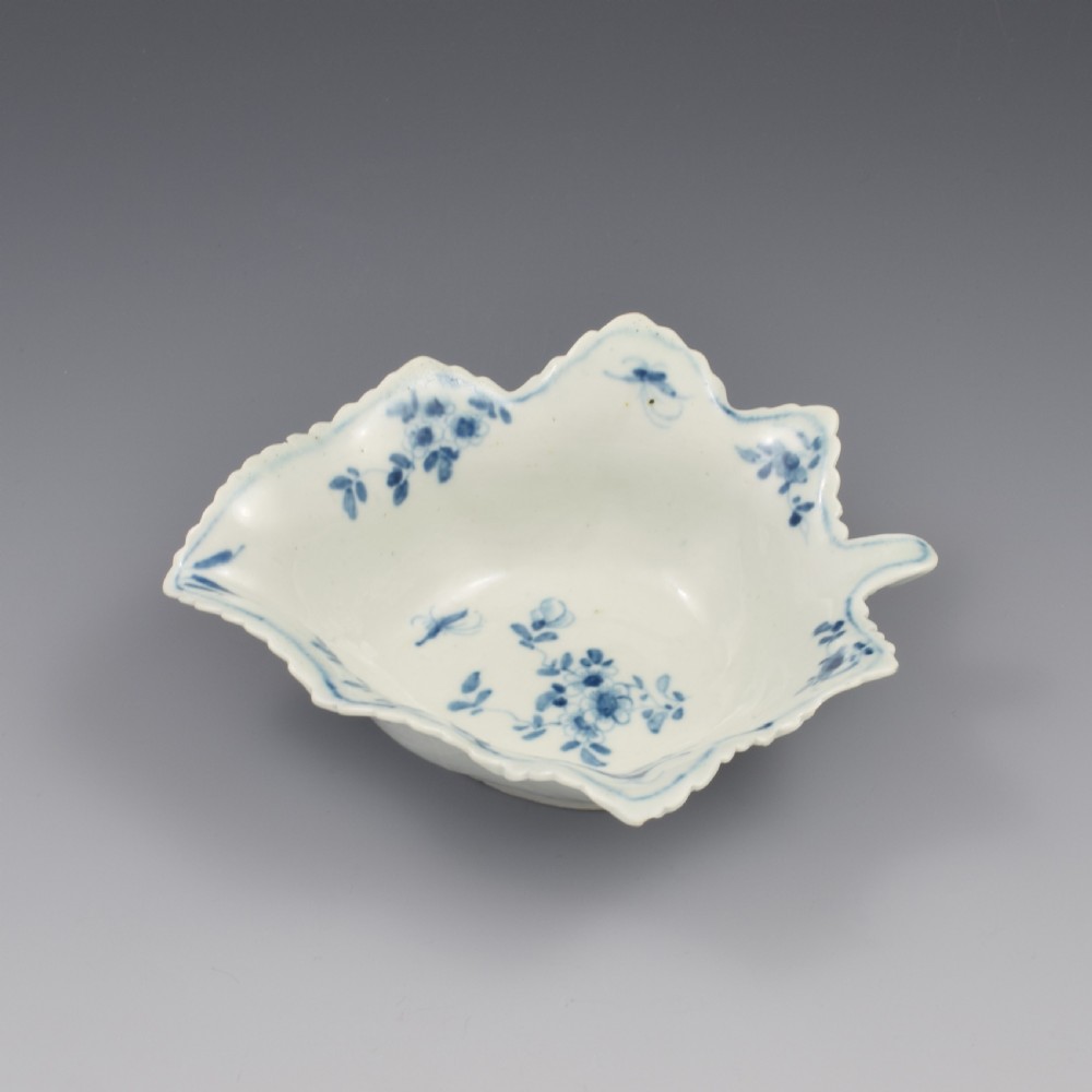 An 18th-century leaf-moulded soft-paste porcelain pickle dish with underglaze cobalt blue floral and leaf decoration. View V