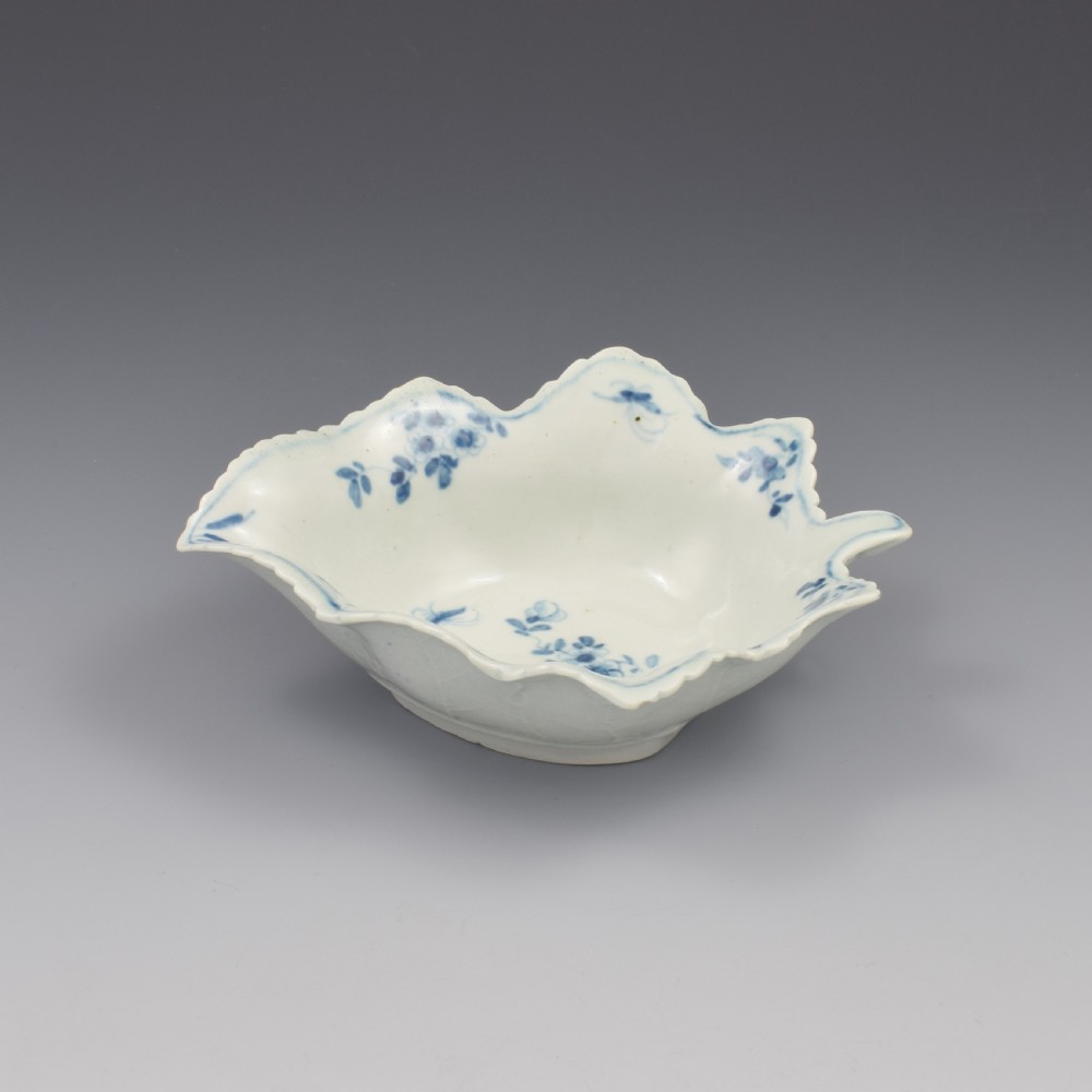 An 18th-century leaf-moulded soft-paste porcelain pickle dish with underglaze cobalt blue floral and leaf decoration. View VI