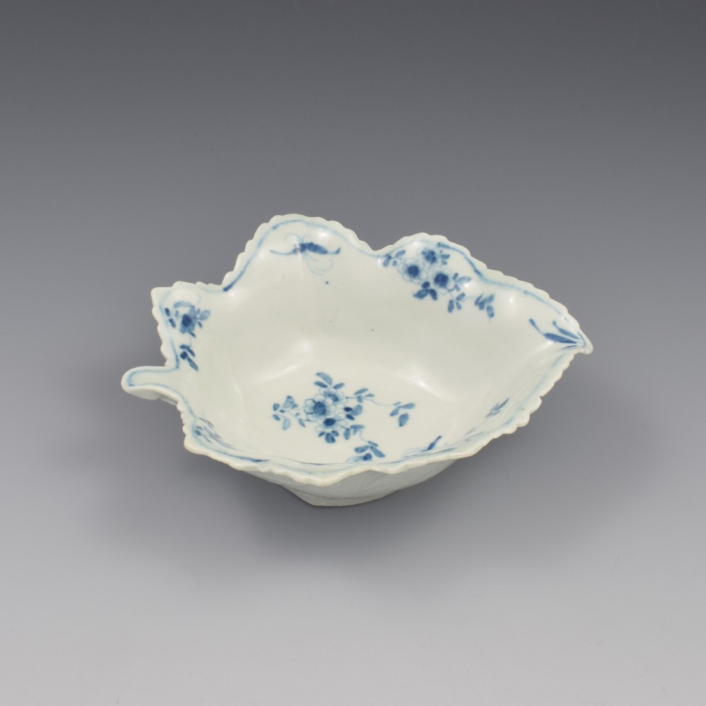 An 18th-century leaf-moulded soft-paste porcelain pickle dish with underglaze cobalt blue floral and leaf decoration. View XIV
