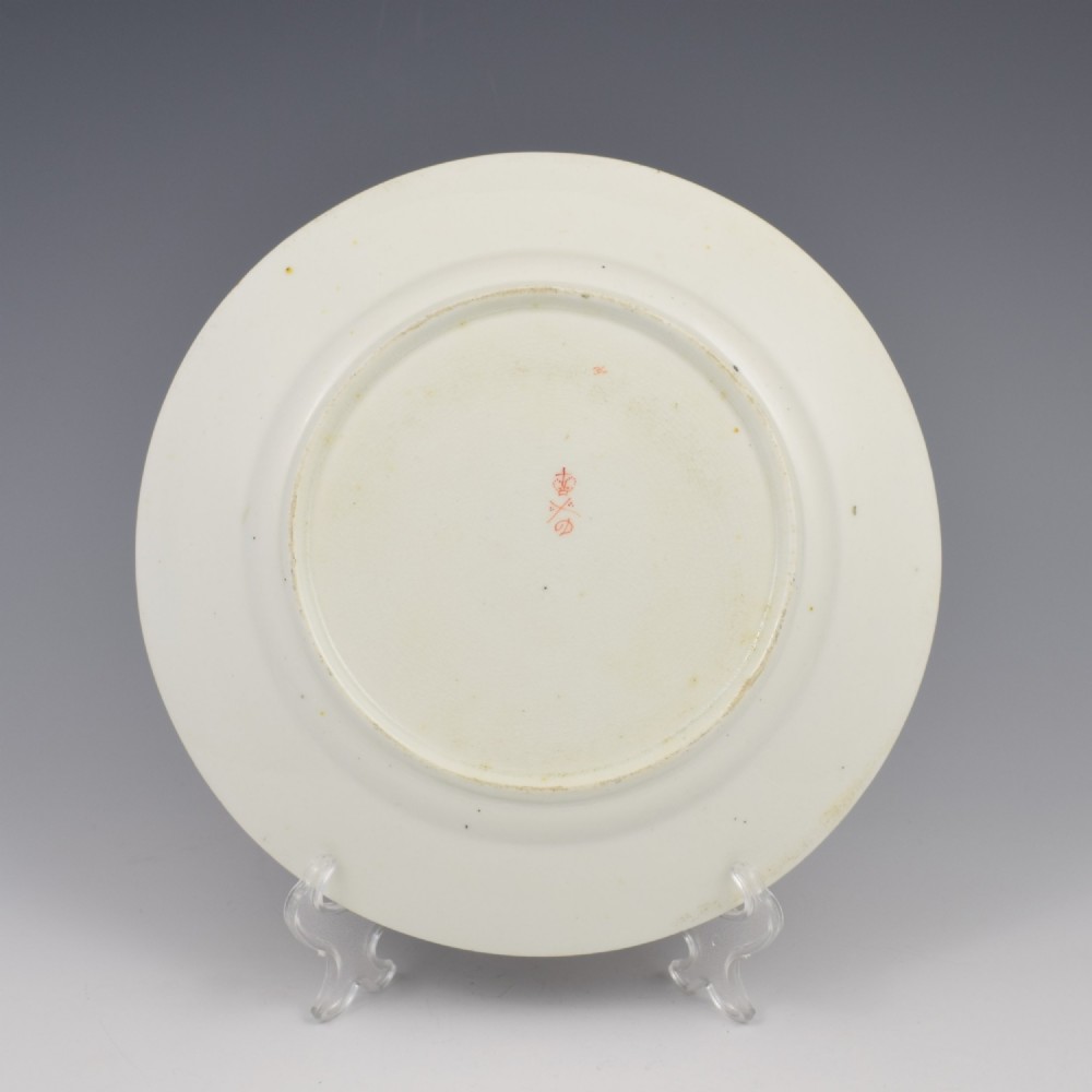 A Regency era Derby porcelain dessert plate featuring a central octagonal panel hand-painted with still-life fruit on a stone ledge, bordered by intricate gold gilding. View III