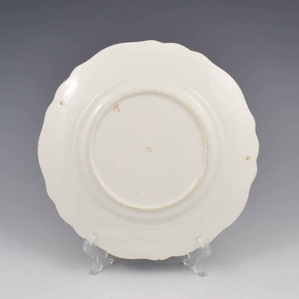 A lobed porcelain dessert plate featuring a rich cobalt blue border with gilded scrollwork and a hand-painted central design of a mythical creature among flowers. View III