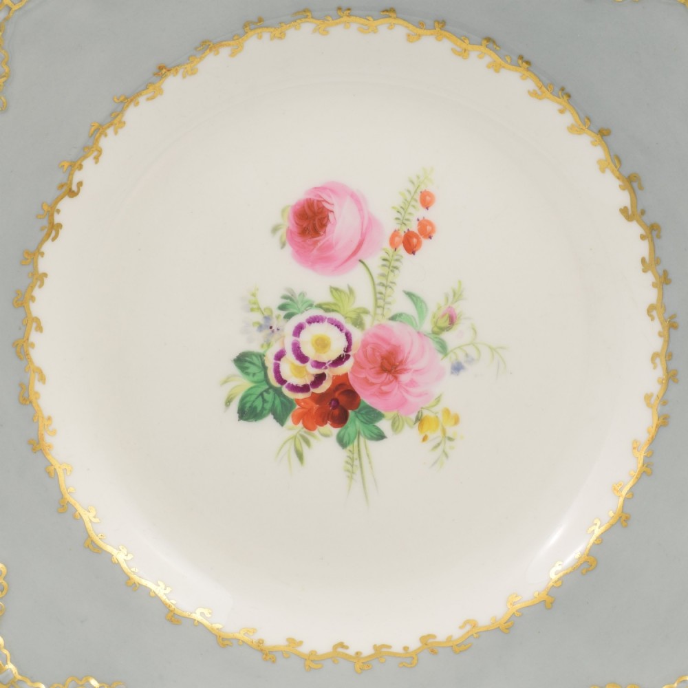 A Victorian John Ridgway porcelain dessert plate featuring a pierced duck-egg grey border with gilt scrollwork and a hand-painted central floral bouquet. View II