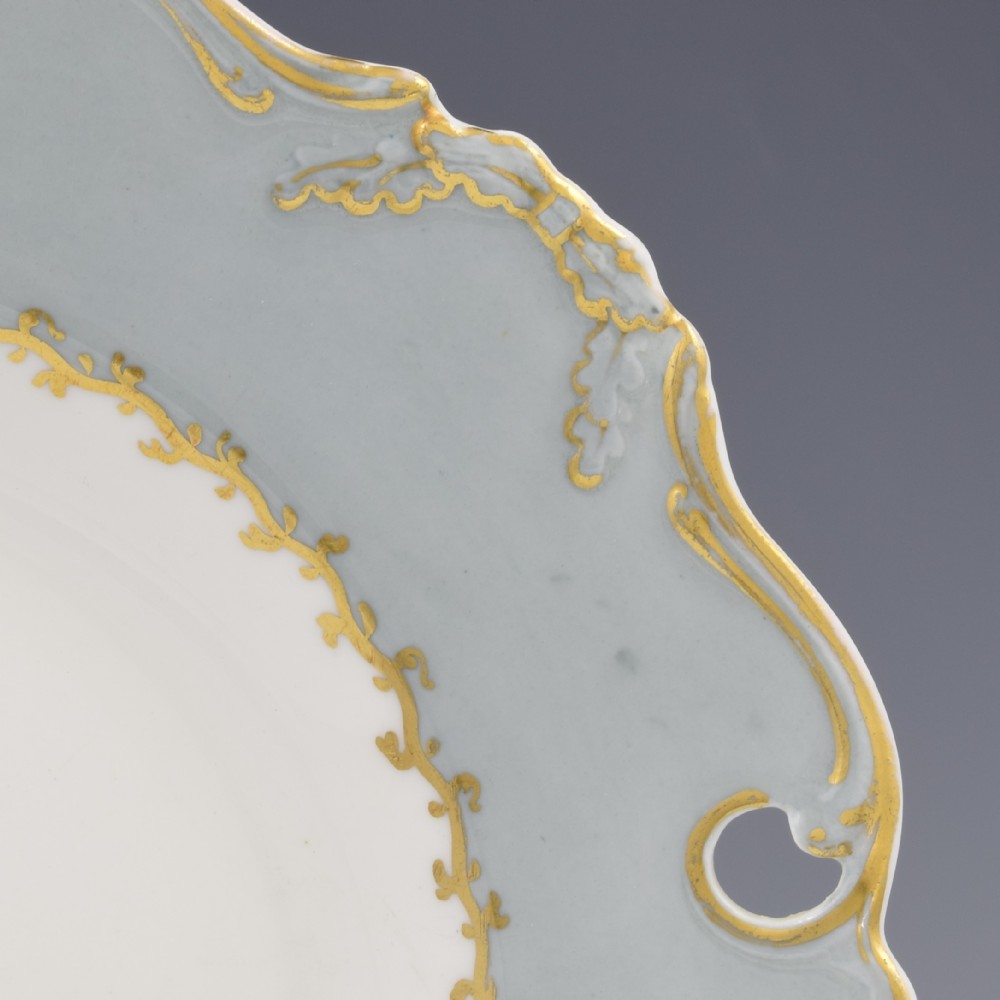 A Victorian John Ridgway porcelain dessert plate featuring a pierced duck-egg grey border with gilt scrollwork and a hand-painted central floral bouquet. View IV