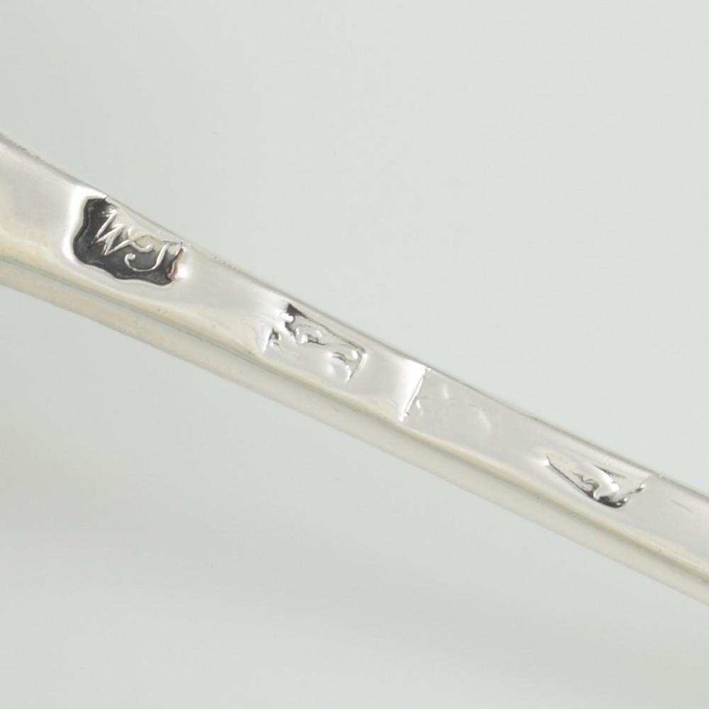 An 18th-century sterling silver sifter spoon featuring an Onslow scroll terminal, feather-edge shaft, and a pierced shell bowl. View XI