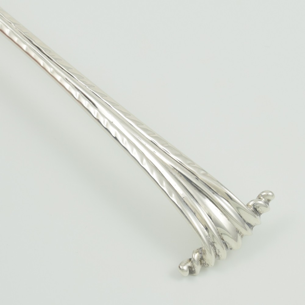 An 18th-century sterling silver sifter spoon featuring an Onslow scroll terminal, feather-edge shaft, and a pierced shell bowl. View XIV