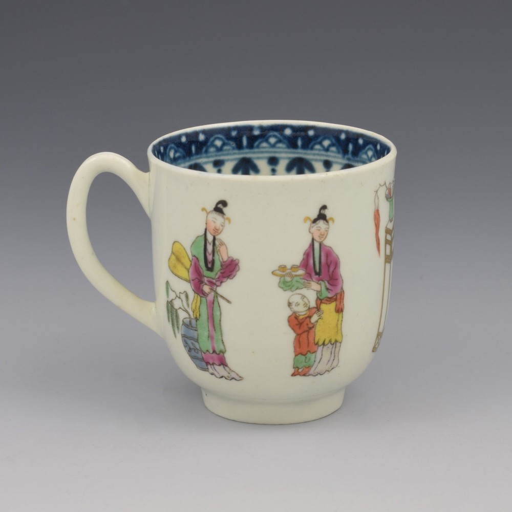 An 18th-century white porcelain coffee cup featuring a hand-painted polychrome figure scene in the Chinoiserie style with a blue patterned inner border. View III
