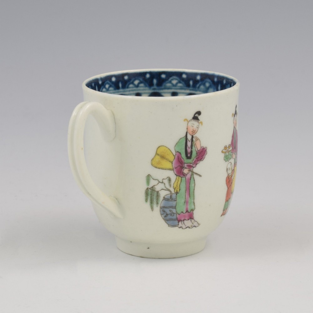 An 18th-century white porcelain coffee cup featuring a hand-painted polychrome figure scene in the Chinoiserie style with a blue patterned inner border. View IV