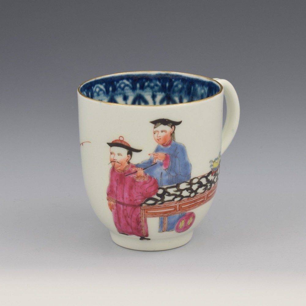 An 18th-century white porcelain coffee cup decorated with hand-painted Chinese figures in red and blue enamel, featuring a single handle and an internal patterned rim. View III