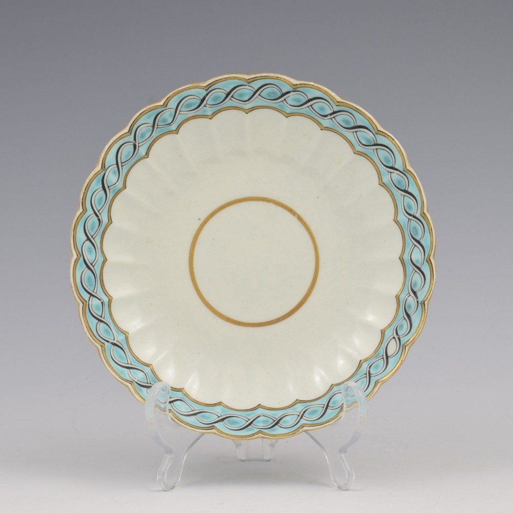 An eighteenth-century Worcester soft-paste porcelain fluted tea bowl and saucer featuring a turquoise and black guilloche border with gilded rim details. View II