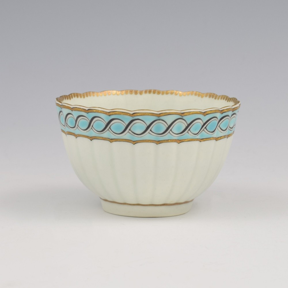 An eighteenth-century Worcester soft-paste porcelain fluted tea bowl and saucer featuring a turquoise and black guilloche border with gilded rim details. View III