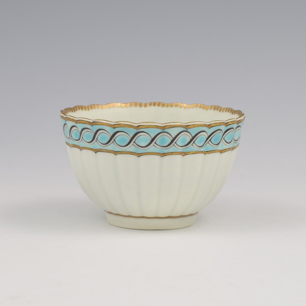 An eighteenth-century Worcester soft-paste porcelain fluted tea bowl and saucer featuring a turquoise and black guilloche border with gilded rim details. View IV