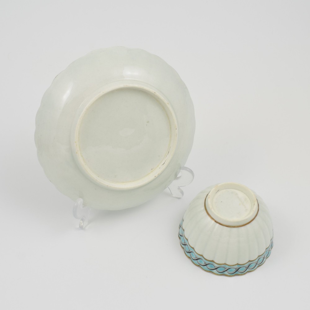 An eighteenth-century Worcester soft-paste porcelain fluted tea bowl and saucer featuring a turquoise and black guilloche border with gilded rim details. View VI