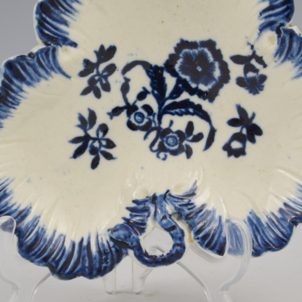 A leaf-shaped Georgian soft-paste porcelain pickle dish decorated with hand-painted underglaze blue floral motifs and a feathered edge. View III