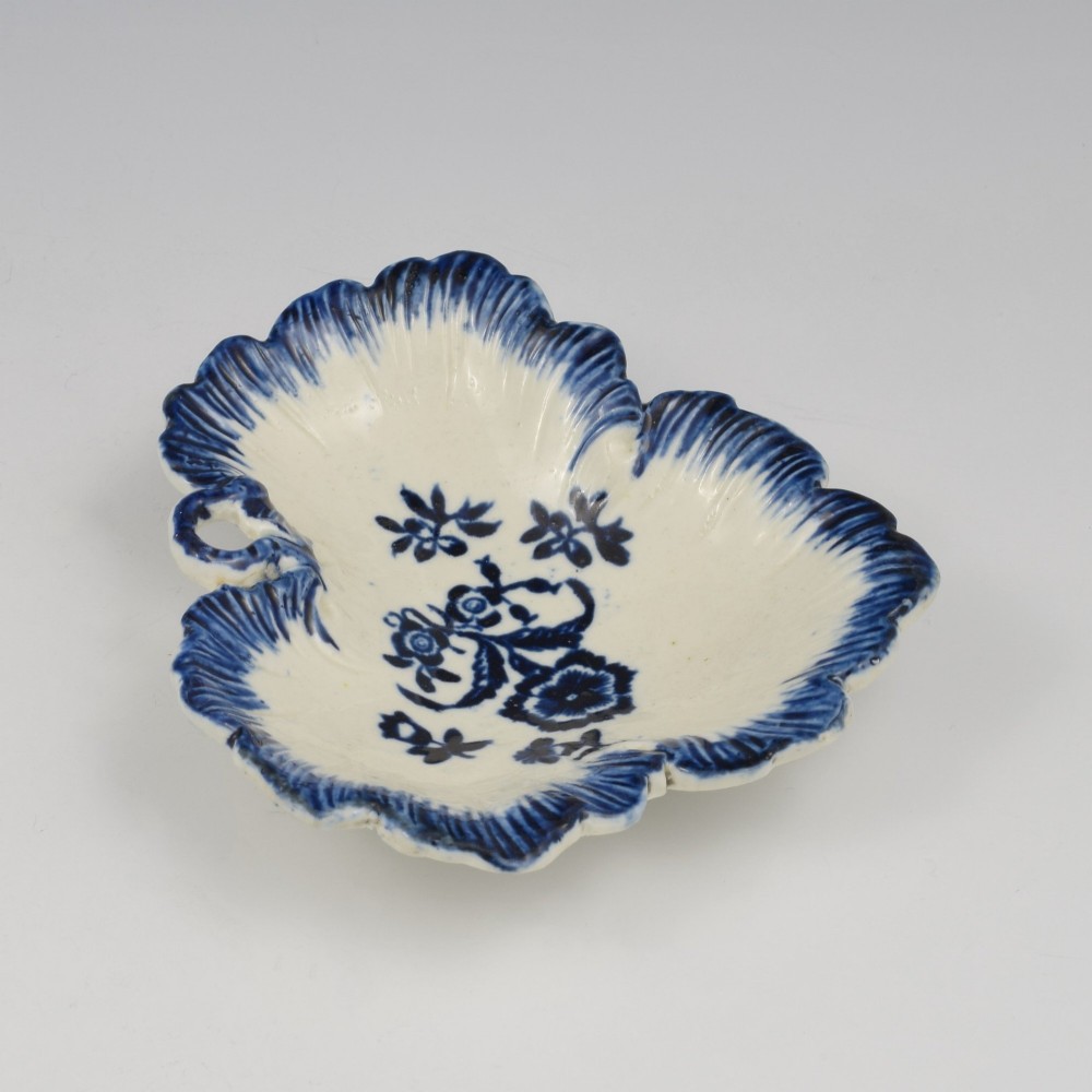 A leaf-shaped Georgian soft-paste porcelain pickle dish decorated with hand-painted underglaze blue floral motifs and a feathered edge. View VII
