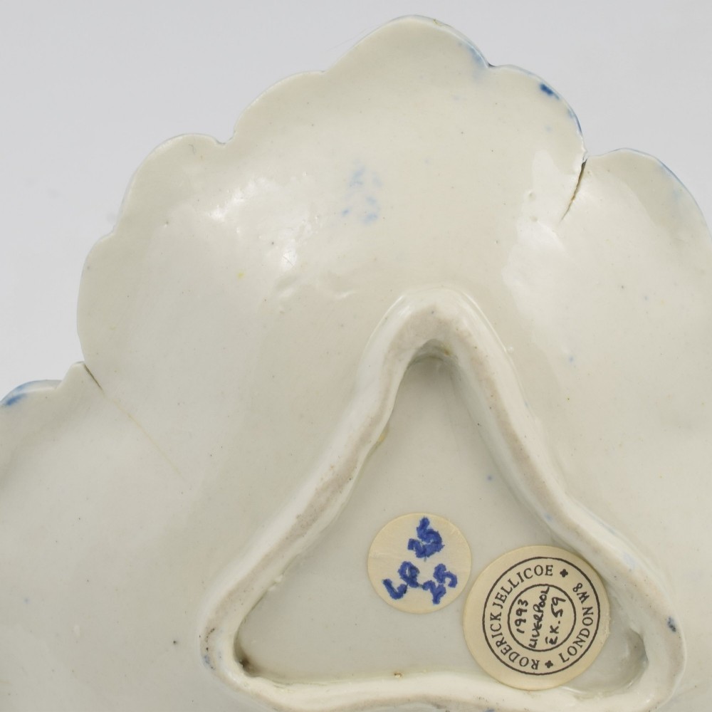 A leaf-shaped Georgian soft-paste porcelain pickle dish decorated with hand-painted underglaze blue floral motifs and a feathered edge. View IX
