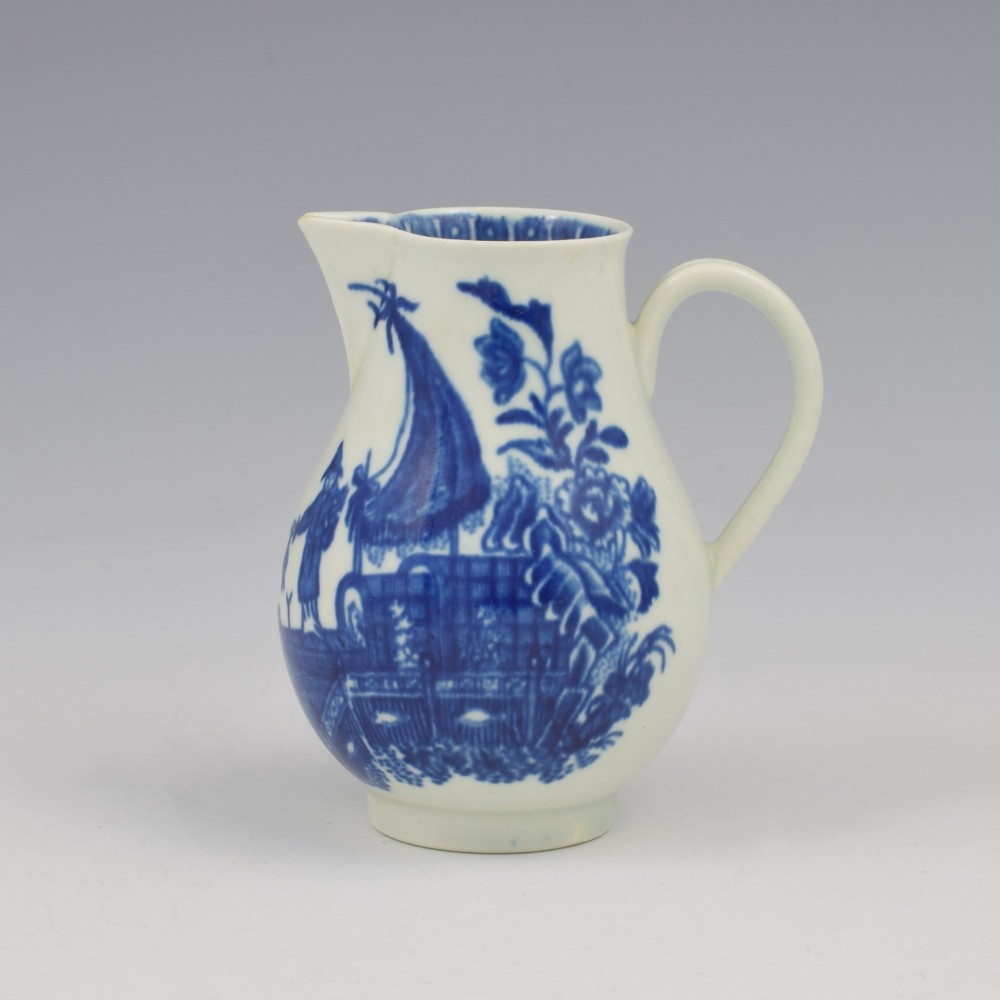 A Georgian First Period Worcester porcelain sparrow beak milk jug decorated with a cobalt blue underglaze fisherman pattern.