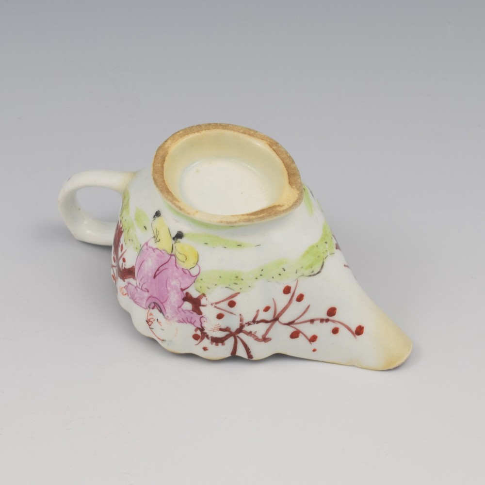 A small 18th-century soft-paste porcelain sauce boat featuring a scalloped fluted rim, loop handle, and hand-painted Chinoiserie figures with a pink interior border. View XII