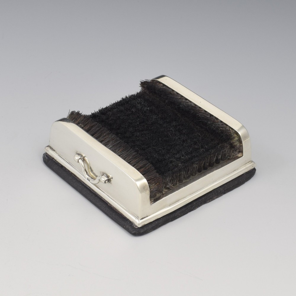An antique Victorian sterling silver novelty pen wipe in the form of a miniature boot scraper with black bristles.
