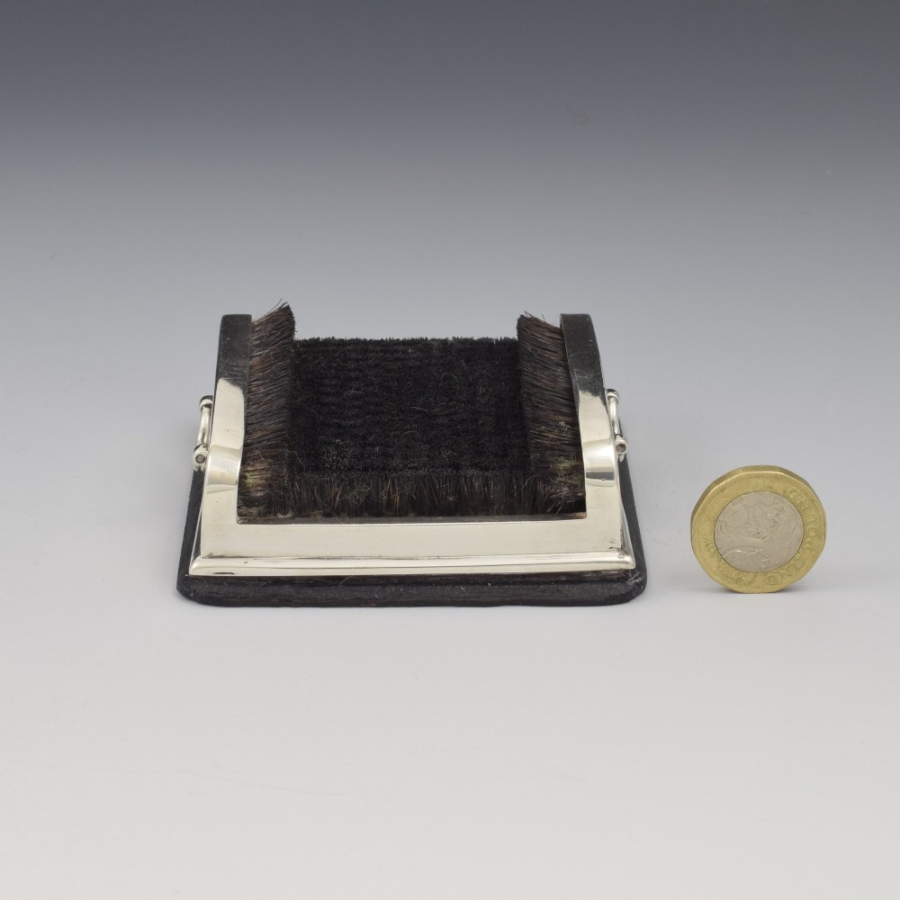 An antique Victorian sterling silver novelty pen wipe in the form of a miniature boot scraper with black bristles. View V