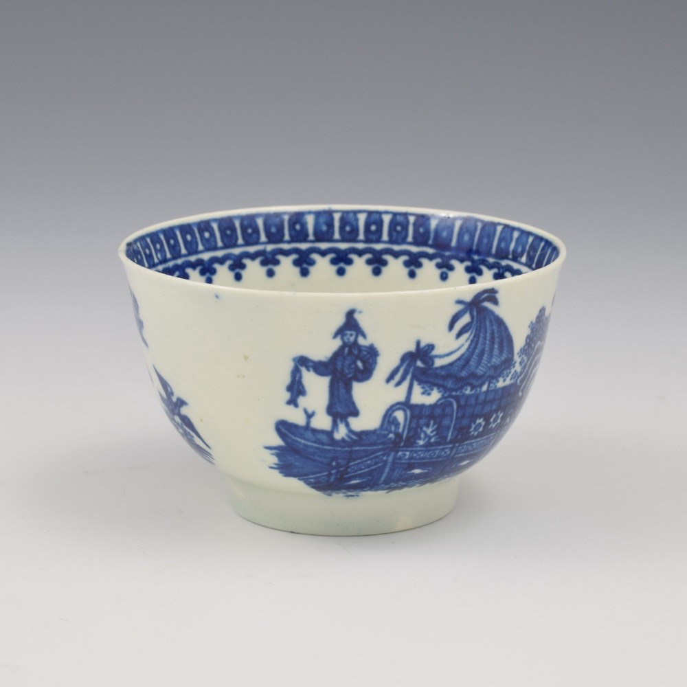 An 18th-century First Period Worcester porcelain tea bowl and saucer set featuring blue underglaze transfer-printed Chinoiserie fisherman patterns. View IV