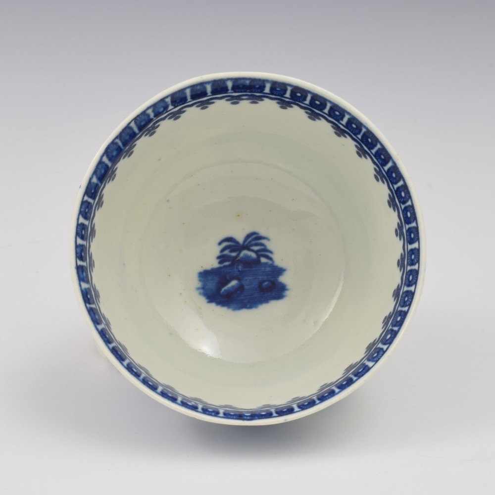 An 18th-century First Period Worcester porcelain tea bowl and saucer set featuring blue underglaze transfer-printed Chinoiserie fisherman patterns. View VIII