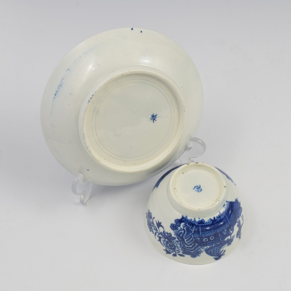 An 18th-century First Period Worcester porcelain tea bowl and saucer set featuring blue underglaze transfer-printed Chinoiserie fisherman patterns. View IX