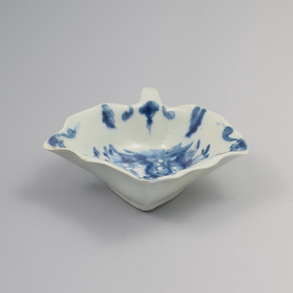 An 18th-century leaf-shaped soft-paste porcelain pickle dish featuring hand-painted chinoiserie motifs in underglaze blue. View V