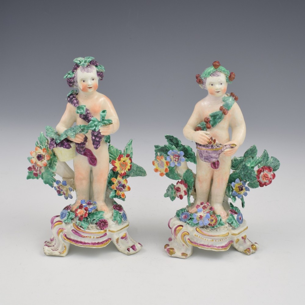 A set of four 18th-century Bow soft-paste porcelain figures representing the seasons, depicting putti on rococo scroll bases with colourful floral bocage. View VI