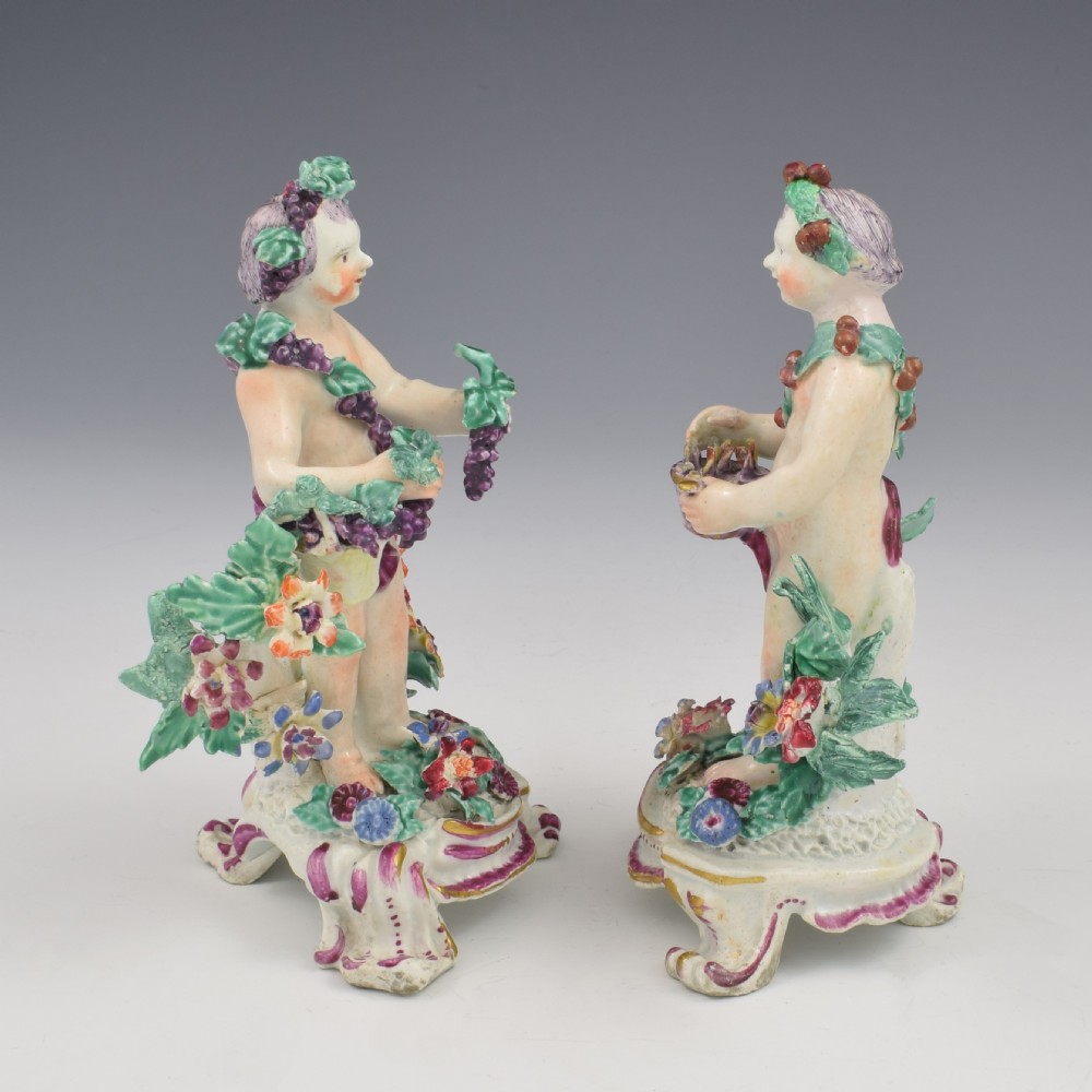 A set of four 18th-century Bow soft-paste porcelain figures representing the seasons, depicting putti on rococo scroll bases with colourful floral bocage. View VIII