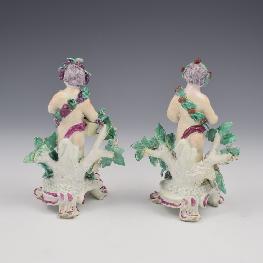 A set of four 18th-century Bow soft-paste porcelain figures representing the seasons, depicting putti on rococo scroll bases with colourful floral bocage. View IX