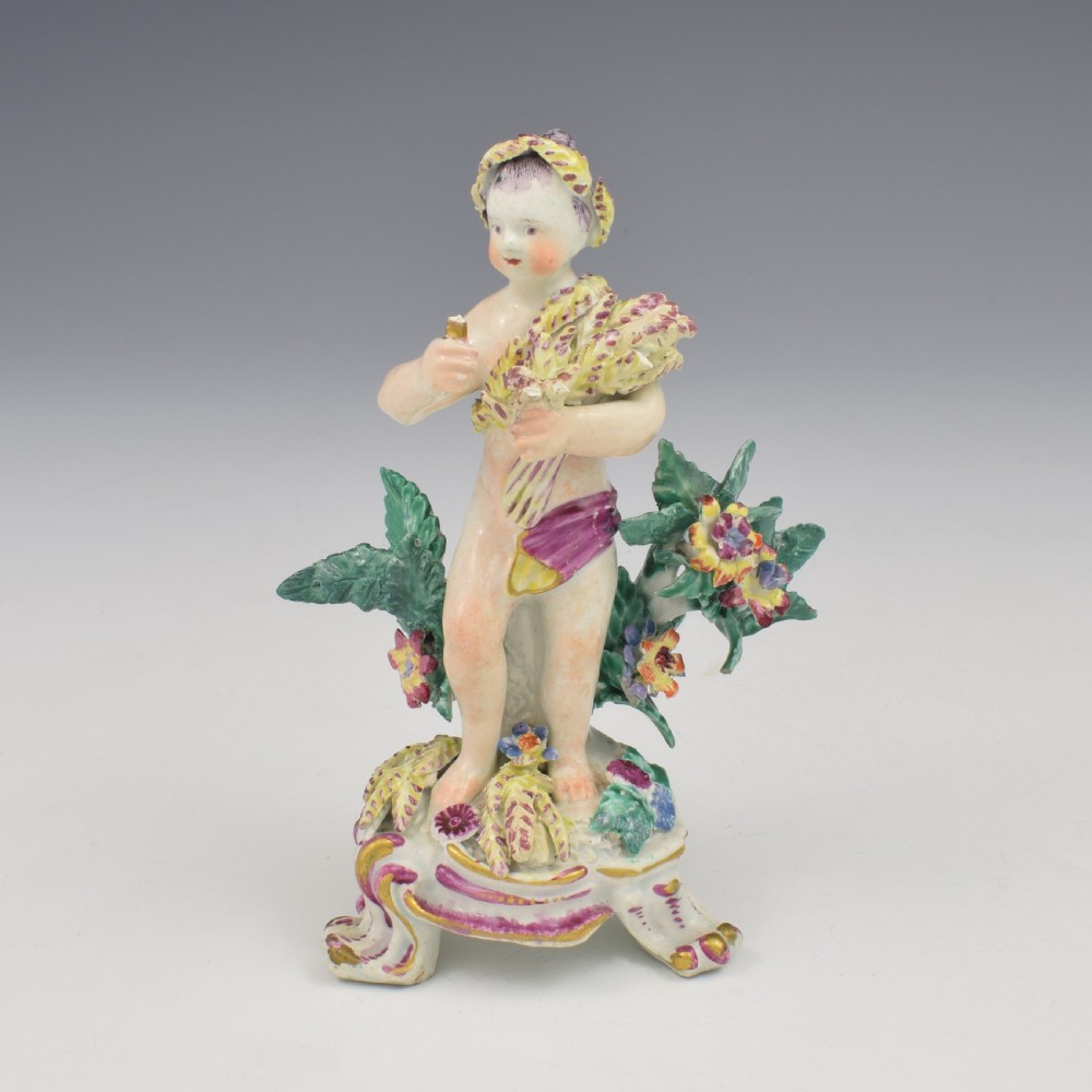 A set of four 18th-century Bow soft-paste porcelain figures representing the seasons, depicting putti on rococo scroll bases with colourful floral bocage. View XVI