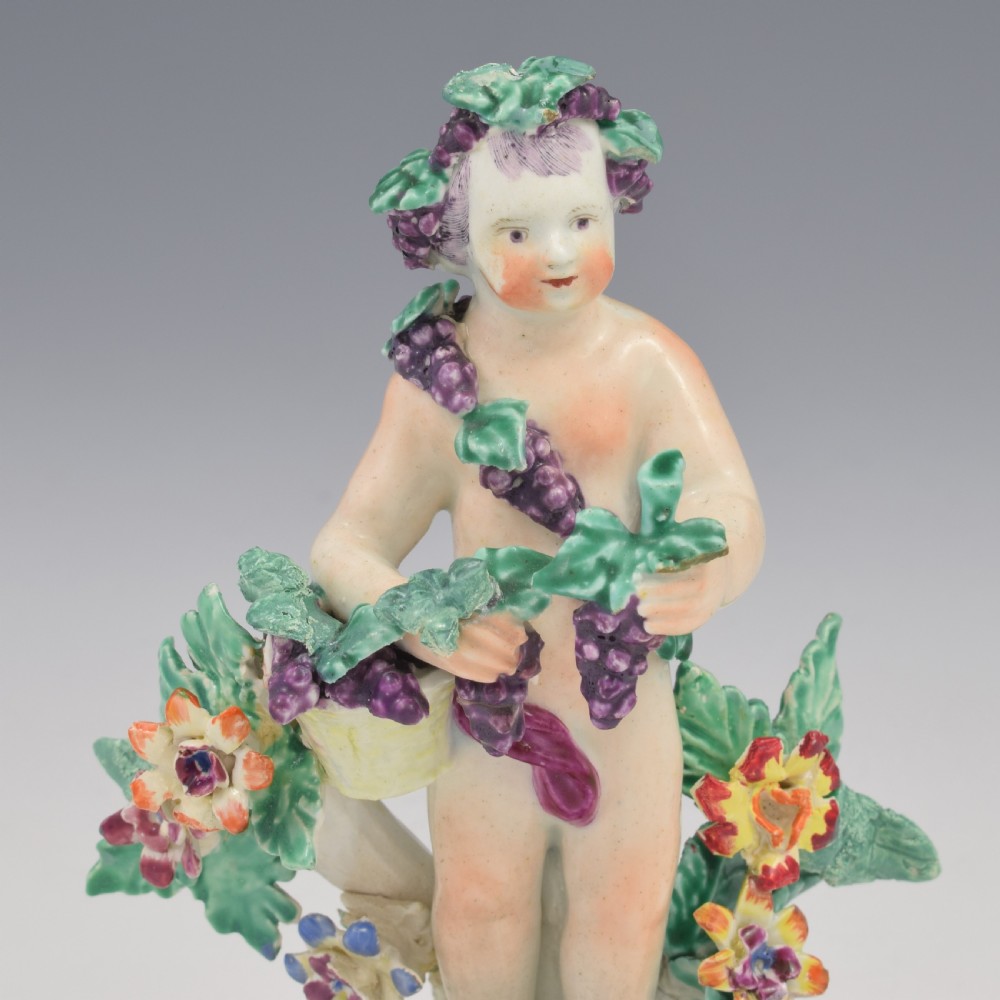 A set of four 18th-century Bow soft-paste porcelain figures representing the seasons, depicting putti on rococo scroll bases with colourful floral bocage. View XIX
